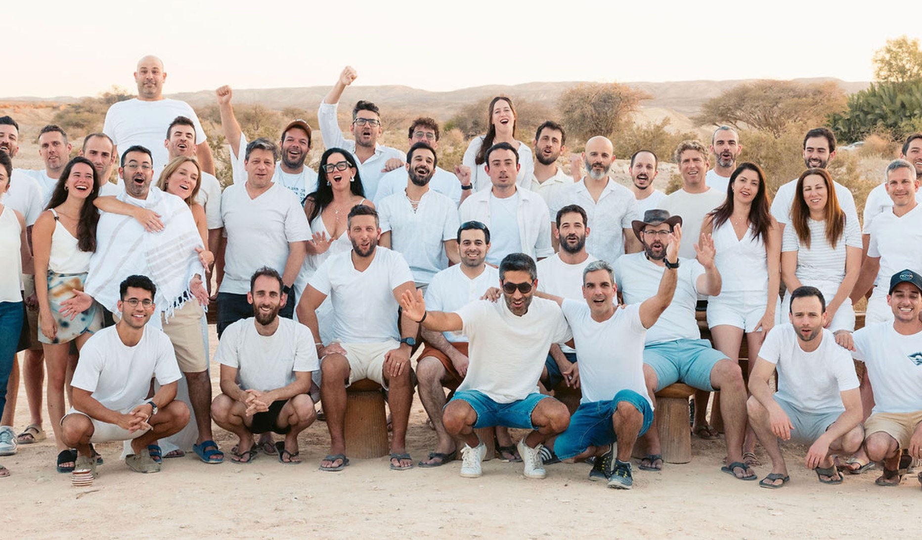 An SV101 batch gathered in the desert, dressed in white